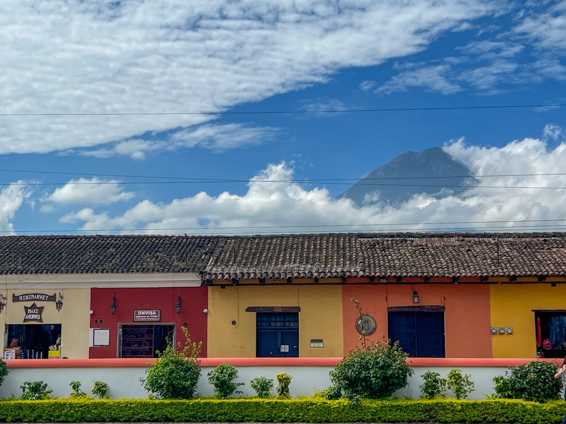 Facciate colorate di case ad Antigua con vulcano sullo sfondo